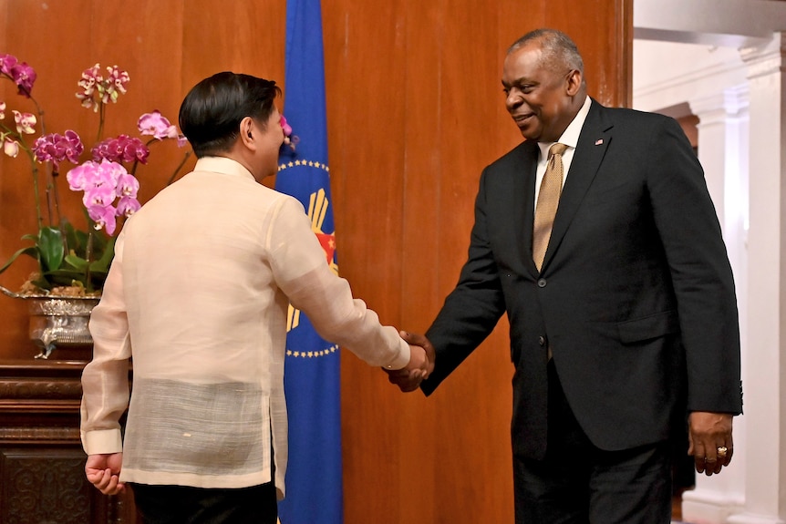 U.S. Secretary of Defense Lloyd James Austin shakes hands with Philippine President Ferdinand Marcos Jr.