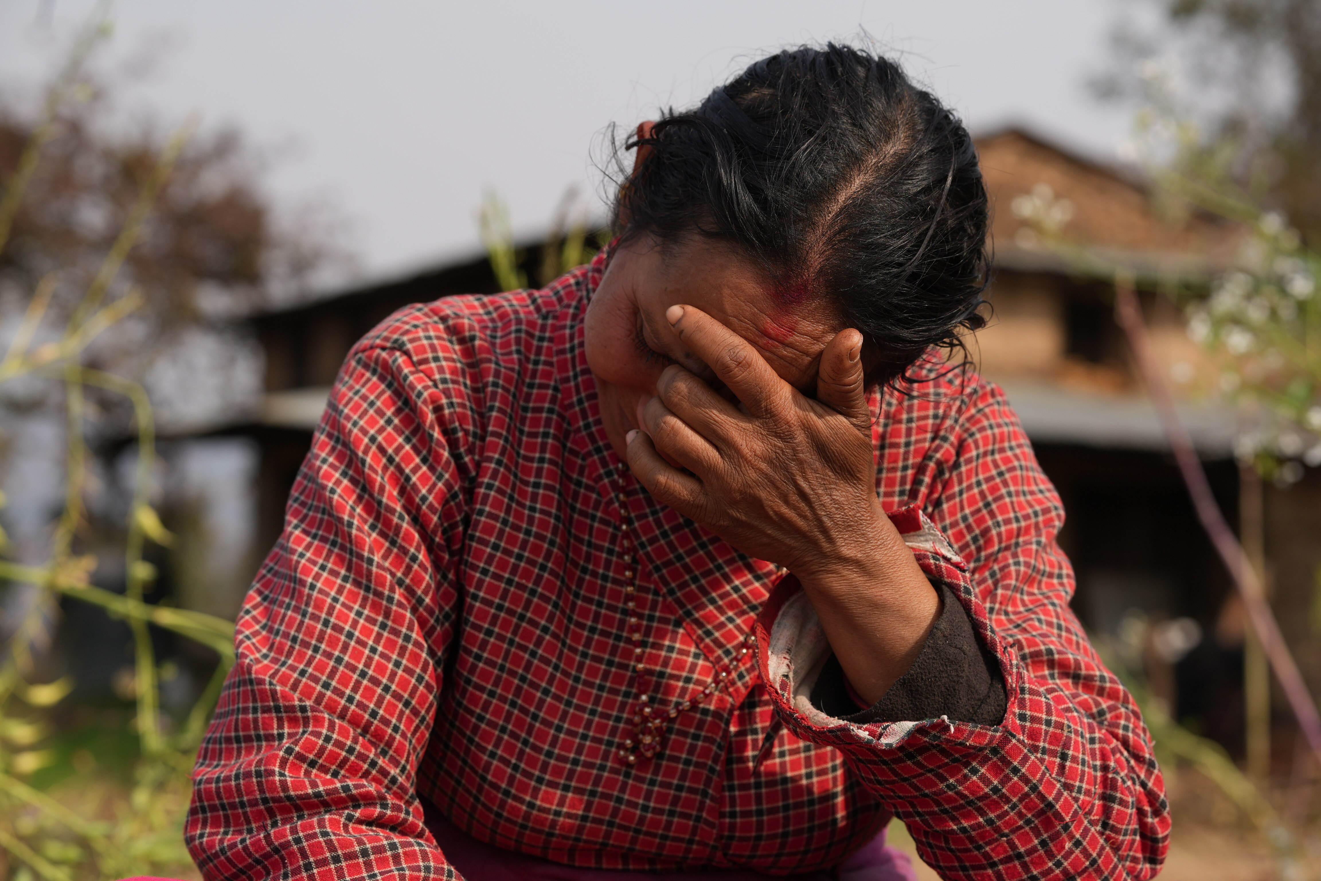 a woman rests her head in her hands 