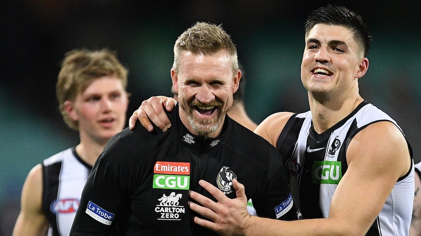 The Collingwood AFL coach and one of his player have a laugh at the SCG.