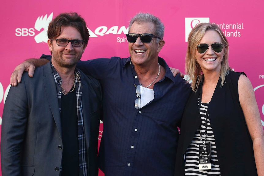 Actor Mel Gibson (centre) poses for photographers with John Polson (left) founder of Tropfest and actress Rebecca Gibney.