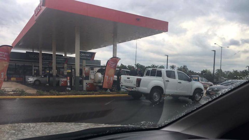 Police with an allegedly stolen Toyota Prado at a service station in Palmerston