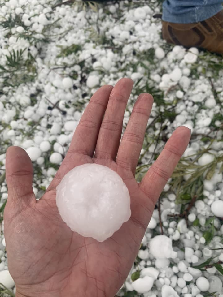 a woman holding a giant hail ball