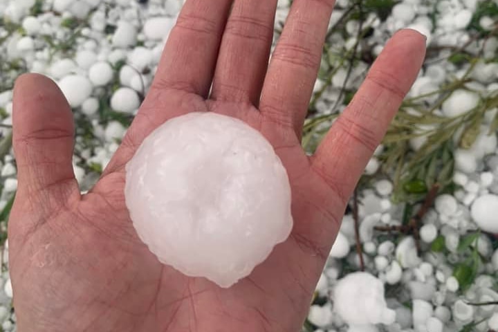 a woman holding a giant hail ball