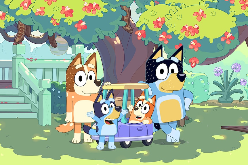Mum, Bluey, Bingo and Dad standing in front of a tree