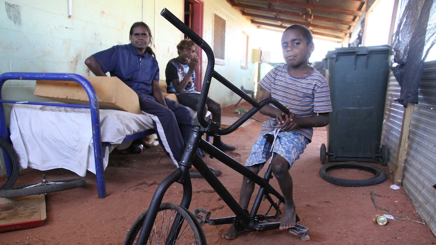Ernie Williams (front) with family members at their accommodation at the small community of Santa Teresa, near Alice Springs.