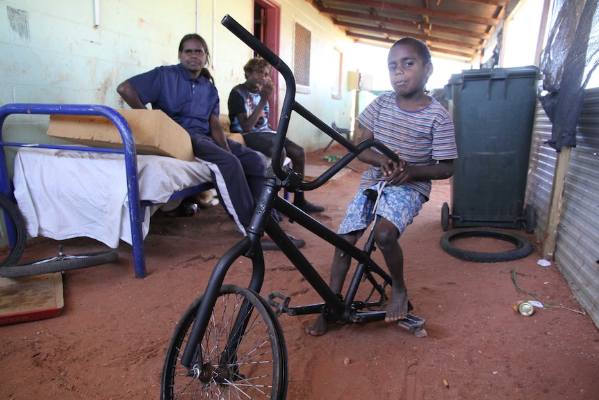 Ernie Williams (front) with family members at their accommodation at the small community of Santa Teresa, near Alice Springs.