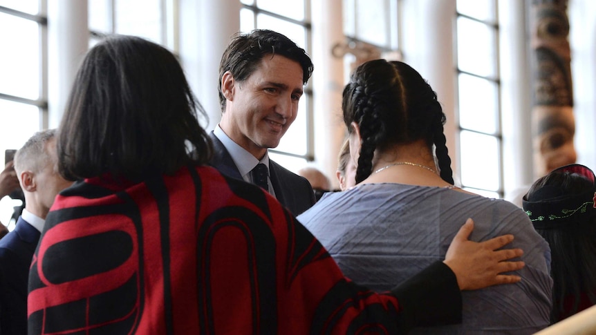 Prime Minister Justin Trudeau greets two women at the national inquiry.