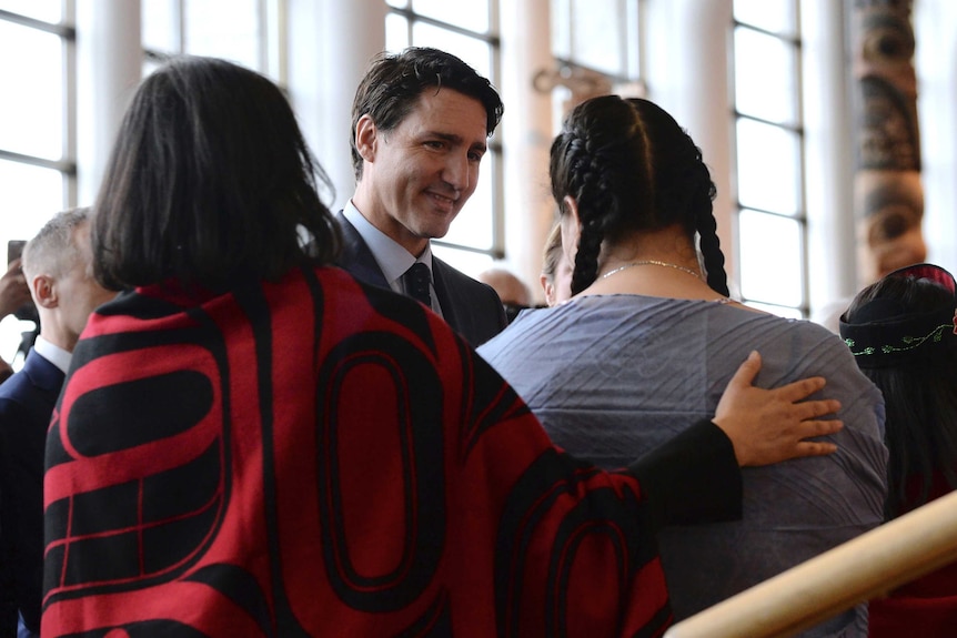 Prime Minister Justin Trudeau greets two women at the national inquiry.