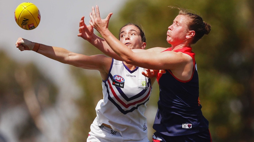 Shelley Scott (right) tries to mark the ball as Laura Pugh attempts to punch it.