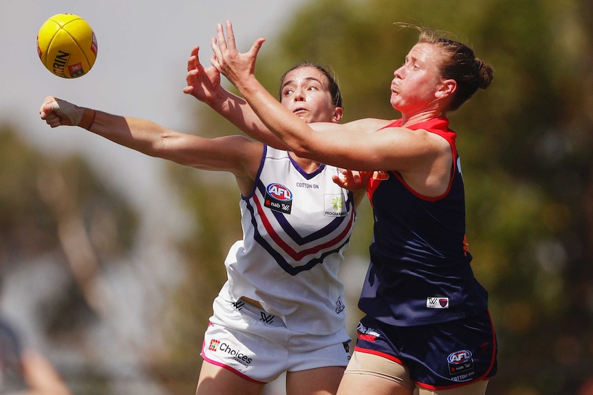 Shelley Scott (right) tries to mark the ball as Laura Pugh attempts to punch it.