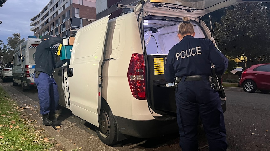 police load evidence into a van