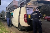 police load evidence into a van