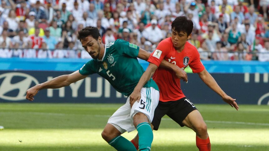 Germany defender Mats Hummels plays the ball against South Korea's Koo Ja-cheol
