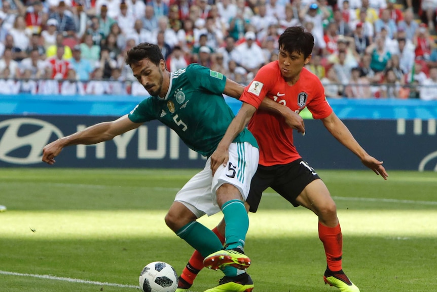 Germany defender Mats Hummels plays the ball against South Korea's Koo Ja-cheol