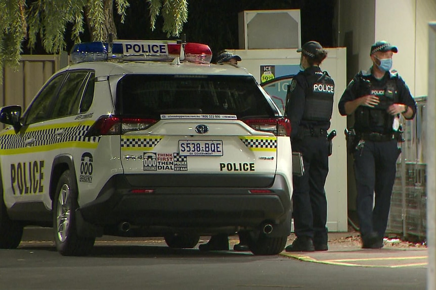 Police at an Adelaide service station following an overnight robbery.