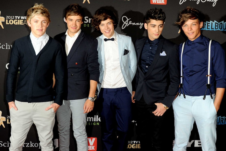 Five boys stand on the red carpet
