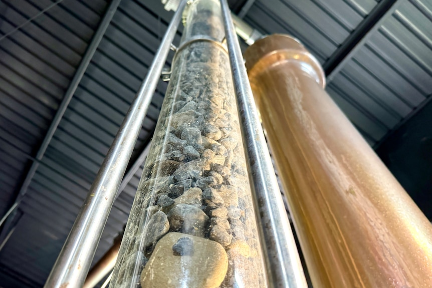 A big glass tube containing rocks.