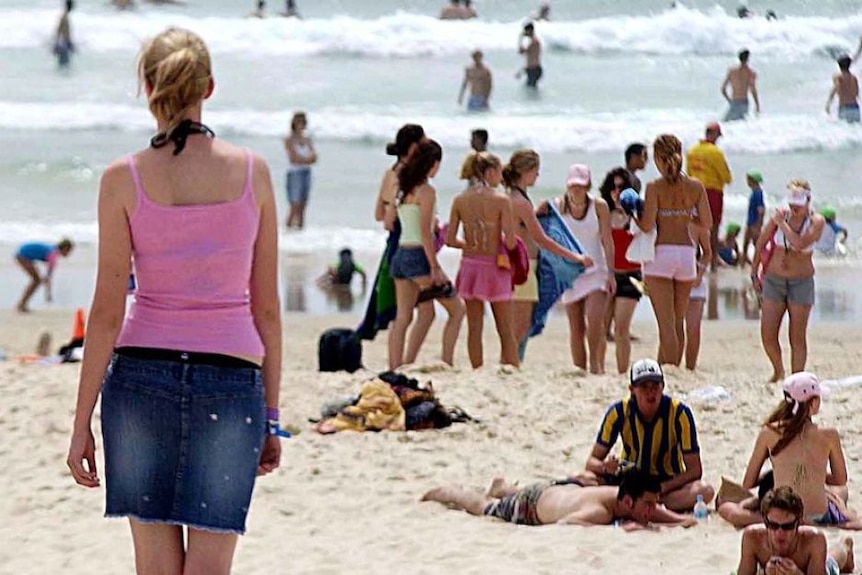 Teenagers on a beach.