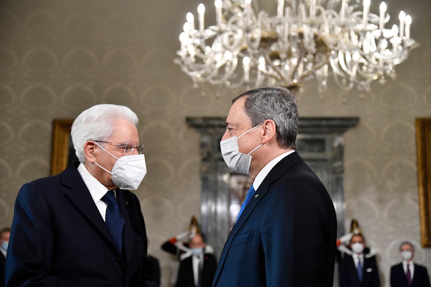 Italy's President Sergio Mattarella, left, greets Italy's Prime Minister Mario Draghi at the Quirinale presidential palace.