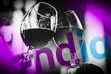 A graphic showing two glasses of red wine being touched above the NDIA logo.