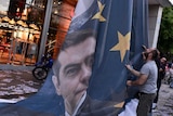Demonstrators take down EU banner of prime minister Alexis Tsipras
