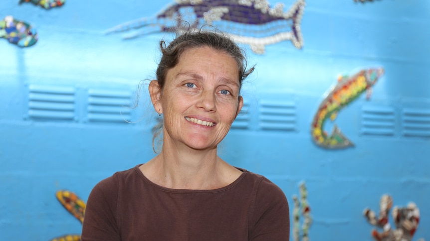 Tanja Nelson in front of sea-themed mural