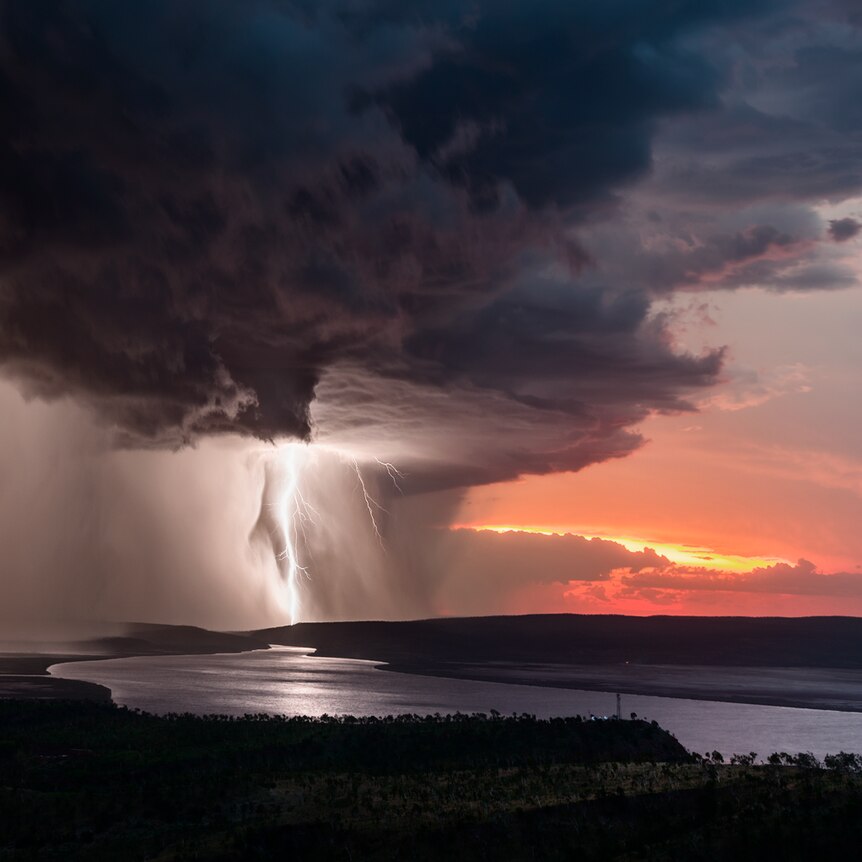 A storm rips through a red sunrise.