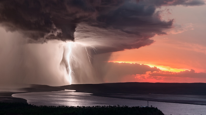 A storm rips through a red sunrise.