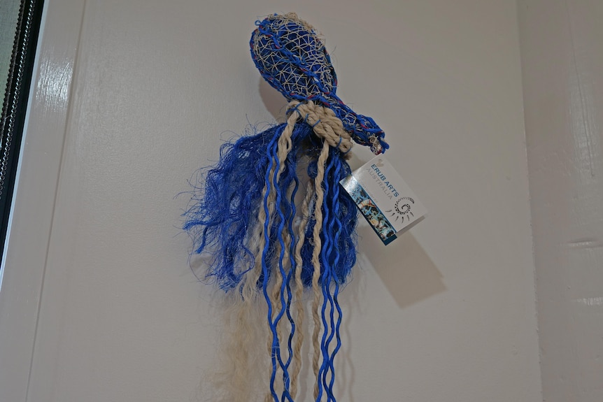 A blue woven artwork in the form of an octopus