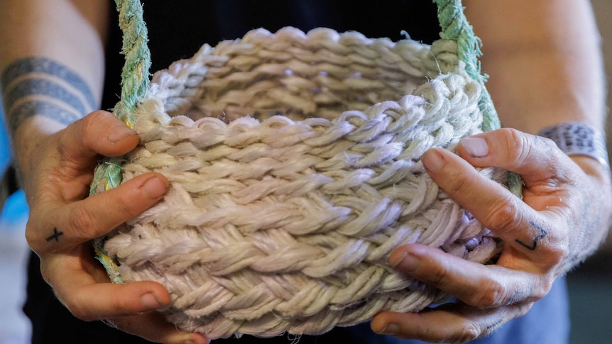Aly de Groot holds a basket made with ghost net
