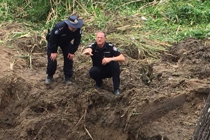 Police dig up a section of roadway