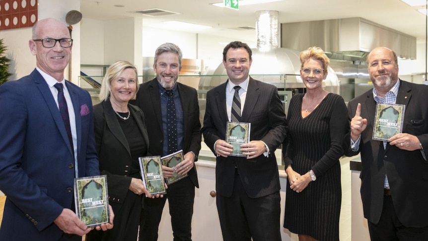 Smiling people holding awards. 