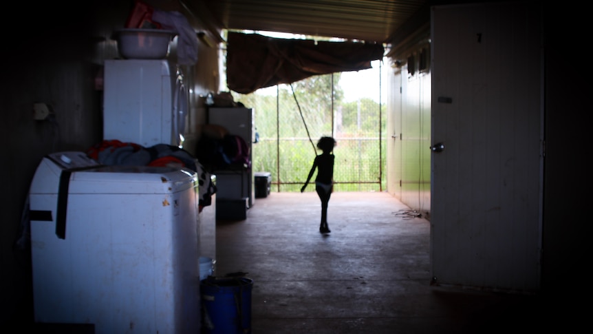 A silhouette of a child walking in a demountable breezeway.