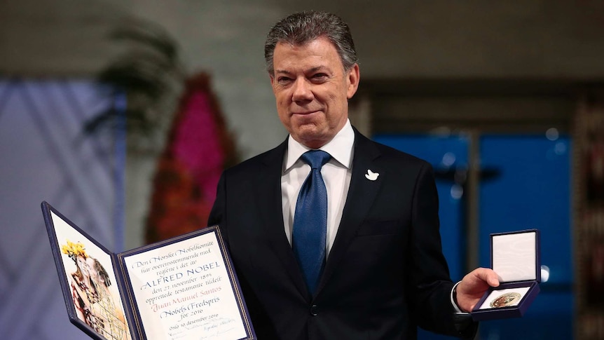 Nobel Peace Prize Laureate and Colombian President Juan Manuel Santos poses with the medal and diploma.