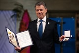 Nobel Peace Prize Laureate and Colombian President Juan Manuel Santos poses with the medal and diploma.