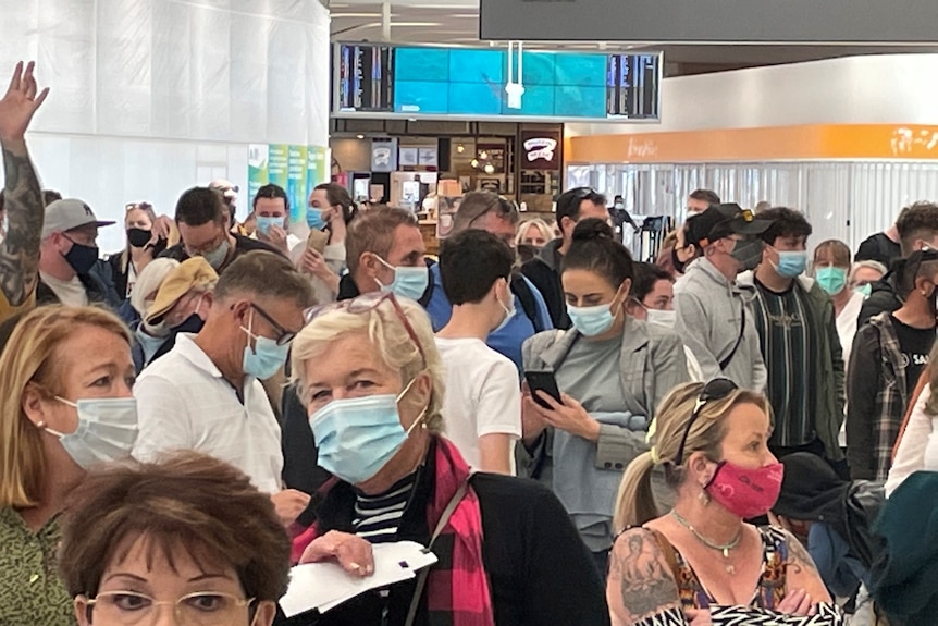 A packed crowd at Adelaide Airport amid an evacuation. 