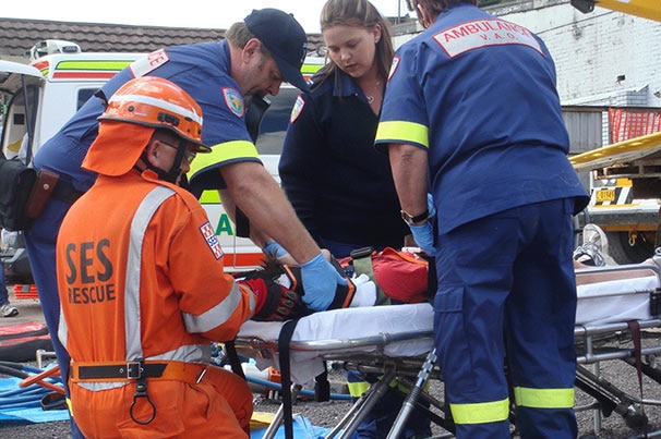 Ambulance Tasmania and SES rescue staff attend to person on gurney.