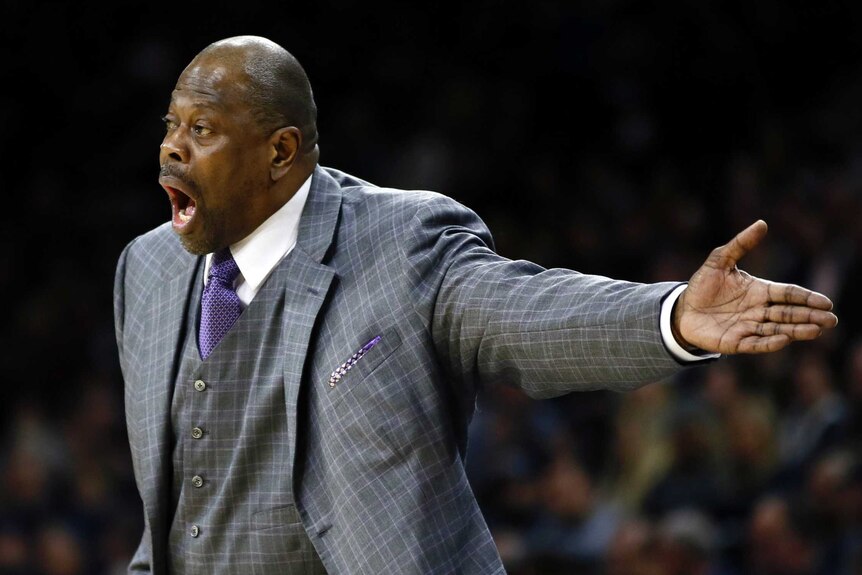 Georgetown men's basketball coach Patrick Ewing yells during a game while wearing a three-piece suit.