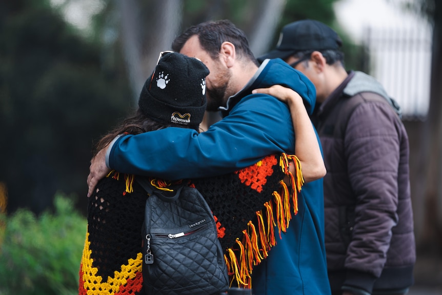 A man and a woman hugging.