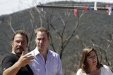 Prince William (centre) chats with bushfire-affected couple Richard and Diane Fox