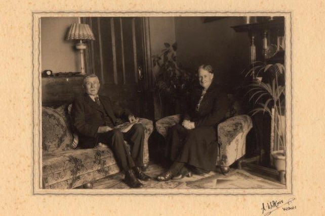 A black and white image of Robert and Emma Gray smiling for the camera. 