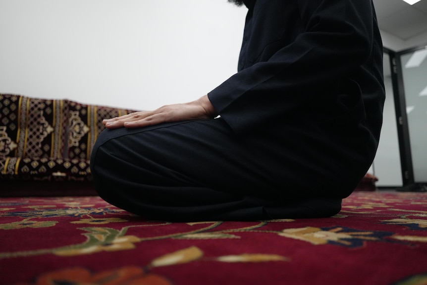 A person kneeling in a prayer room