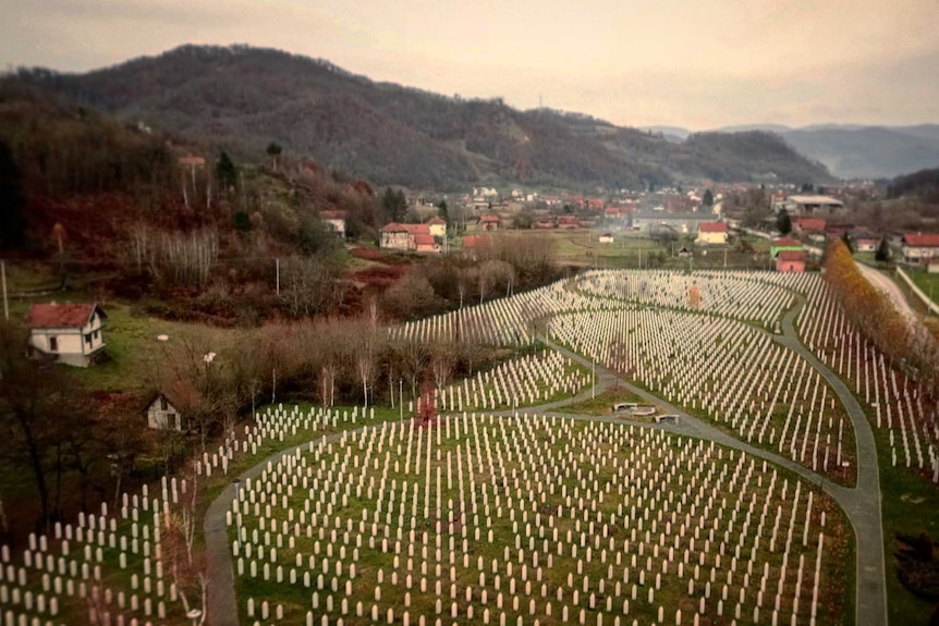 View looking over Srebrenica memorial with rows of graves below