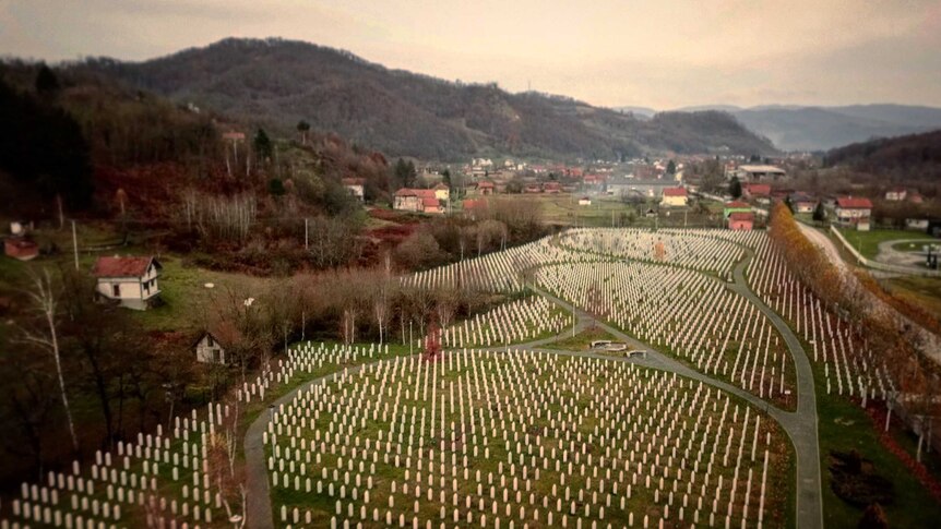 View looking over Srebrenica memorial with rows of graves below