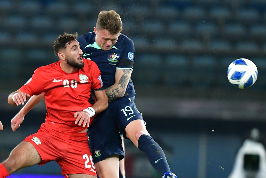 Harry Souttar heads the ball