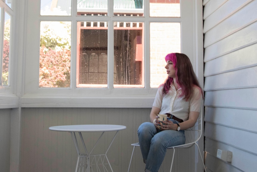 Woman sitting outside on the verandah.