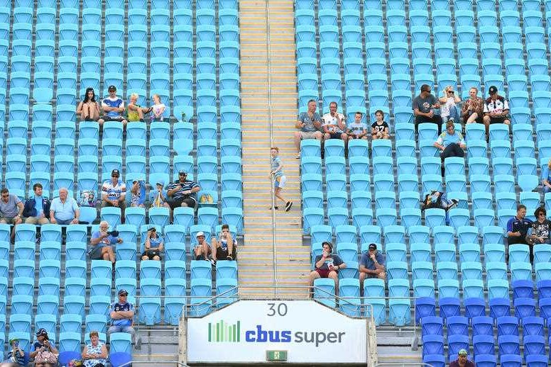 A small number of fans is seen in a largely empty granstand.
