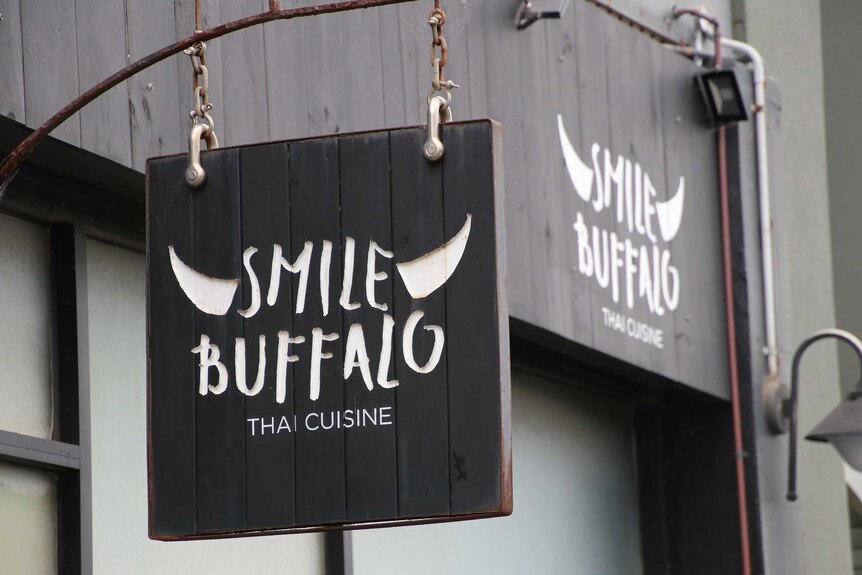 The Smile Buffalo restaurant logo on a sign.
