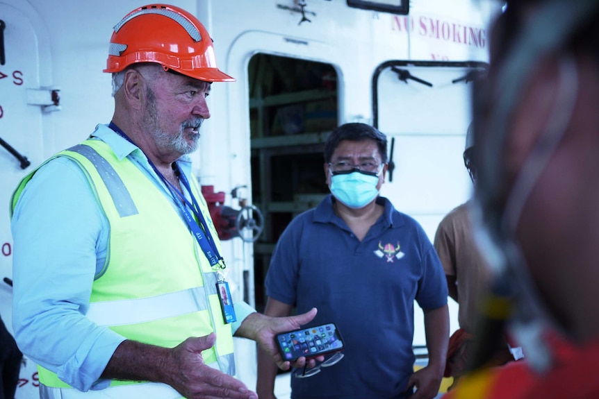 Union official Dean Summers talks to seafarers on a ship docked at Sydney's Port Botany.