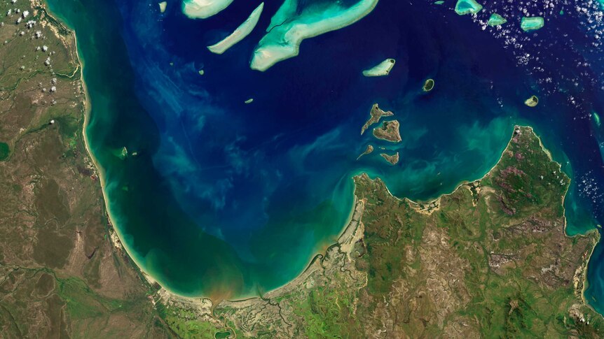 A satellite picture of dirty water running into the reef lagoon.
